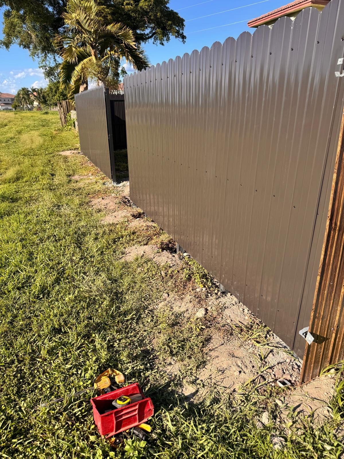 Finished dark metal privacy fence installed by Legacy Fence Pros